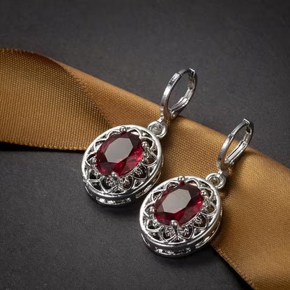 A Pair of Hollowed-out Petal Earrings with Egg-shaped Inlays, a Commemorative Gift