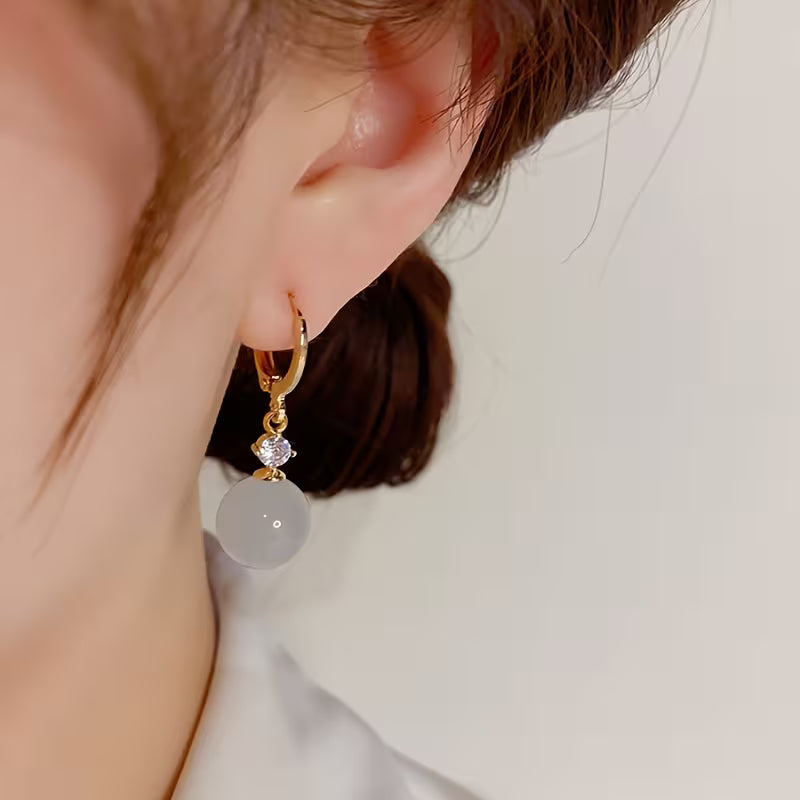 A Pair of Elegant Bohemian Cat's Eye Stone Pendant Earrings, Adorned with Round Synthetic Synthetic Zirconia, Suitable for Women's Daily Wear, Banquets, and Vacations