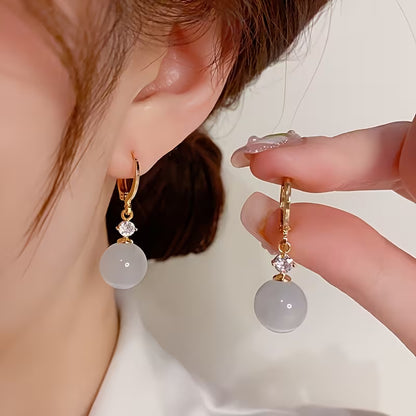 A Pair of Elegant Bohemian Cat's Eye Stone Pendant Earrings, Adorned with Round Synthetic Synthetic Zirconia, Suitable for Women's Daily Wear, Banquets, and Vacations