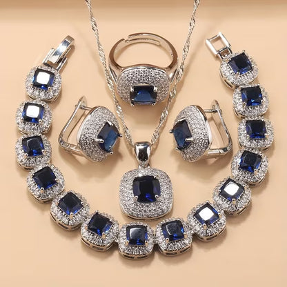 A Newly Designed Square Zirconia Fashion Jewelry Set for Women, Including Earrings, a Necklace with a Pendant, a Bracelet, And an Adjustable Ring Suitable for Various Occasions