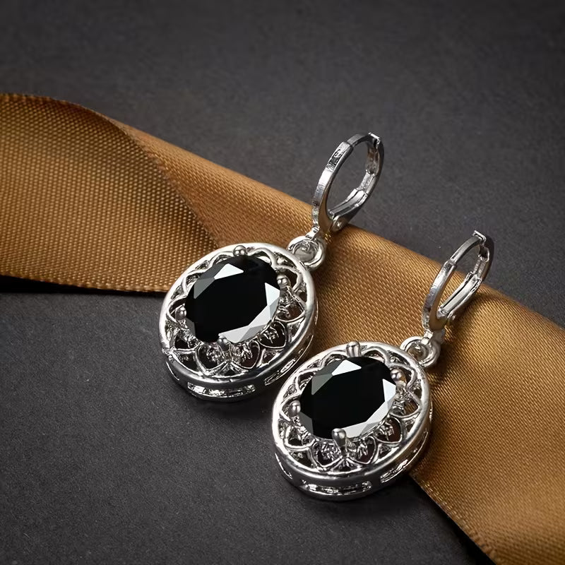 A Pair of Hollowed-out Petal Earrings with Egg-shaped Inlays, a Commemorative Gift