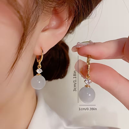 A Pair of Elegant Bohemian Cat's Eye Stone Pendant Earrings, Adorned with Round Synthetic Synthetic Zirconia, Suitable for Women's Daily Wear, Banquets, and Vacations