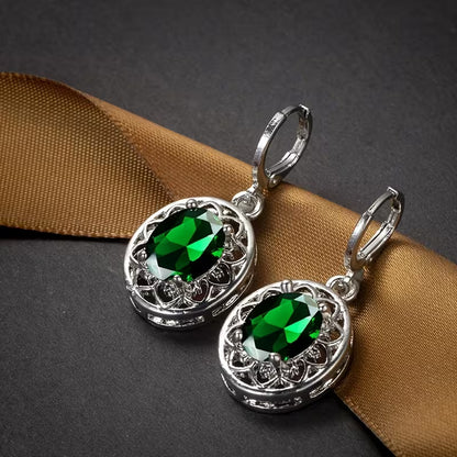 A Pair of Hollowed-out Petal Earrings with Egg-shaped Inlays, a Commemorative Gift